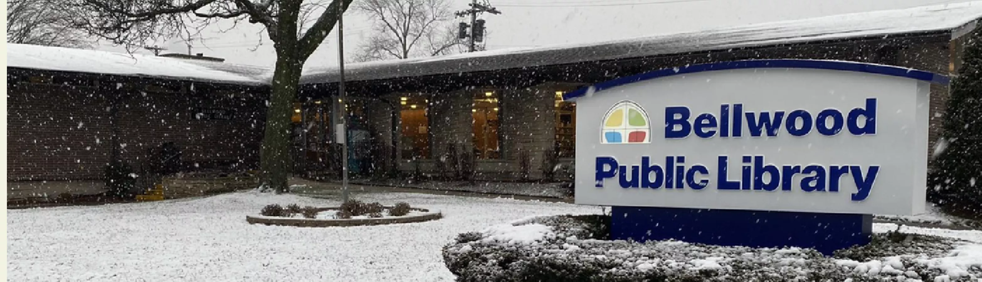 A wintery photo of the exterior of Bellwood Public Library.